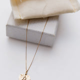 14k Light Yellow Gold Twin Flame Medal and Dangling Heart Moonstone Necklace / CELINE DAOUST