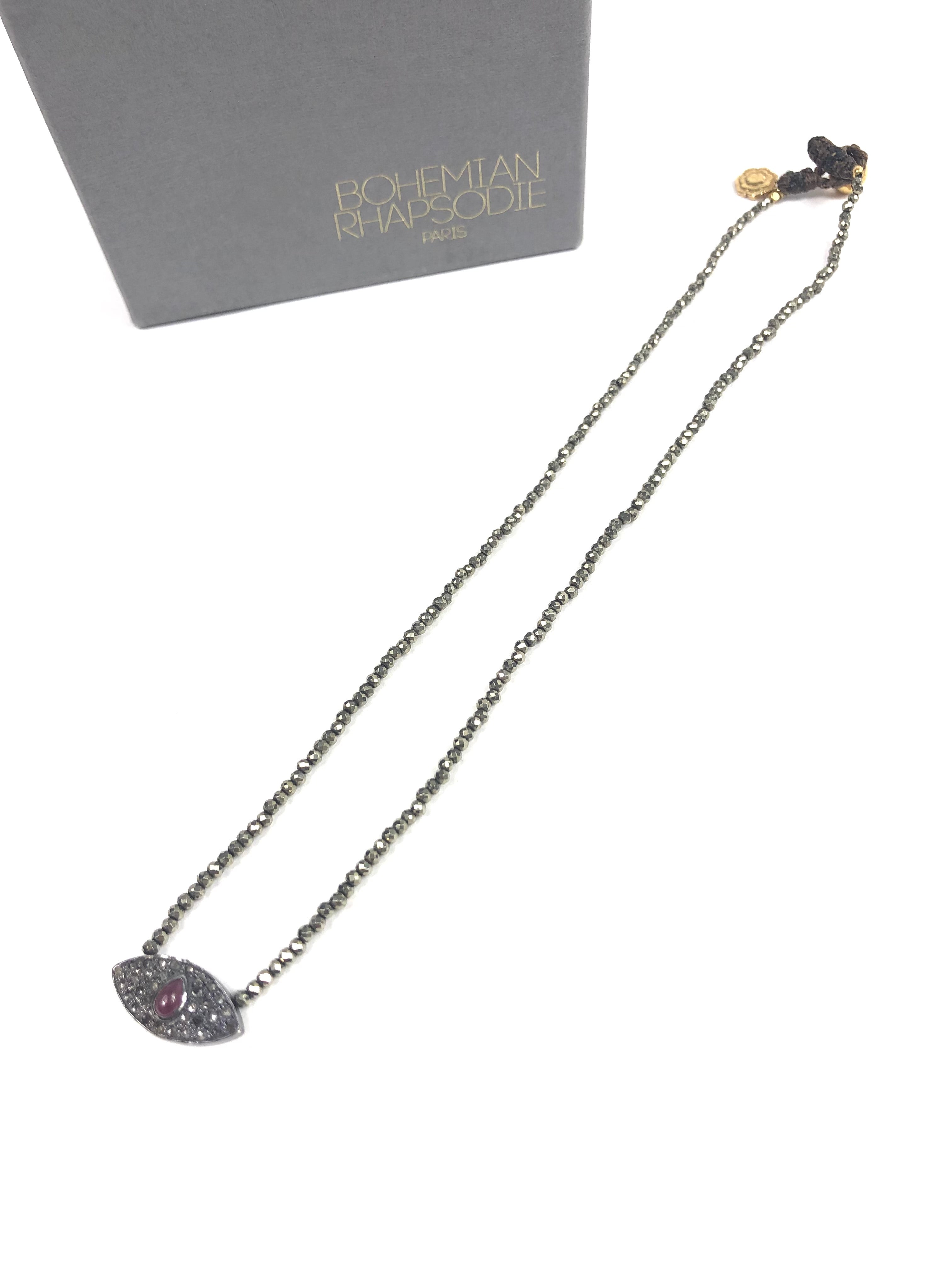 Necklace with eye-shaped pendant on a white background, branded 'Bohemian rhapsodie'.