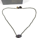 Necklace with eye-shaped pendant on a white background