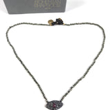 Necklace with eye-shaped pendant on a white background