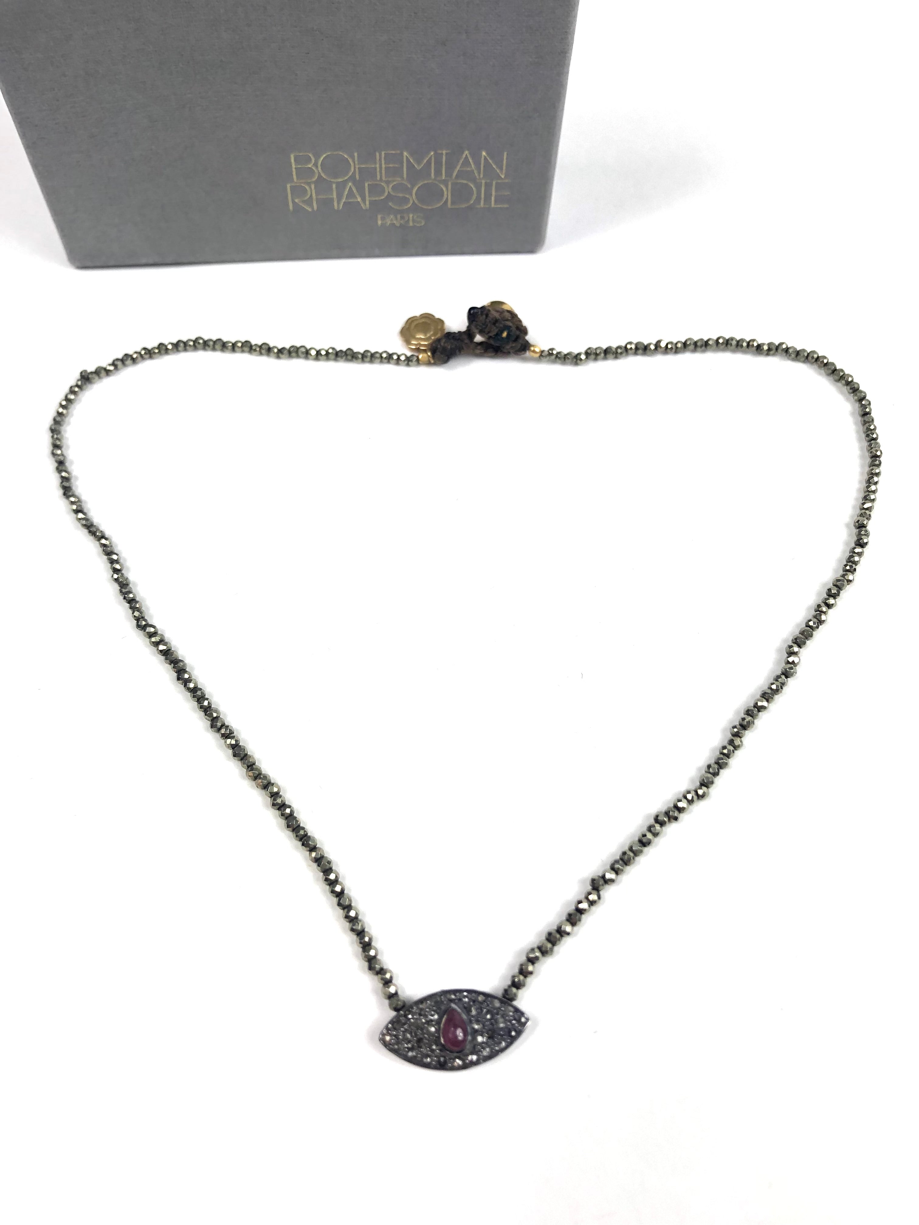 Necklace with eye-shaped pendant on a white background