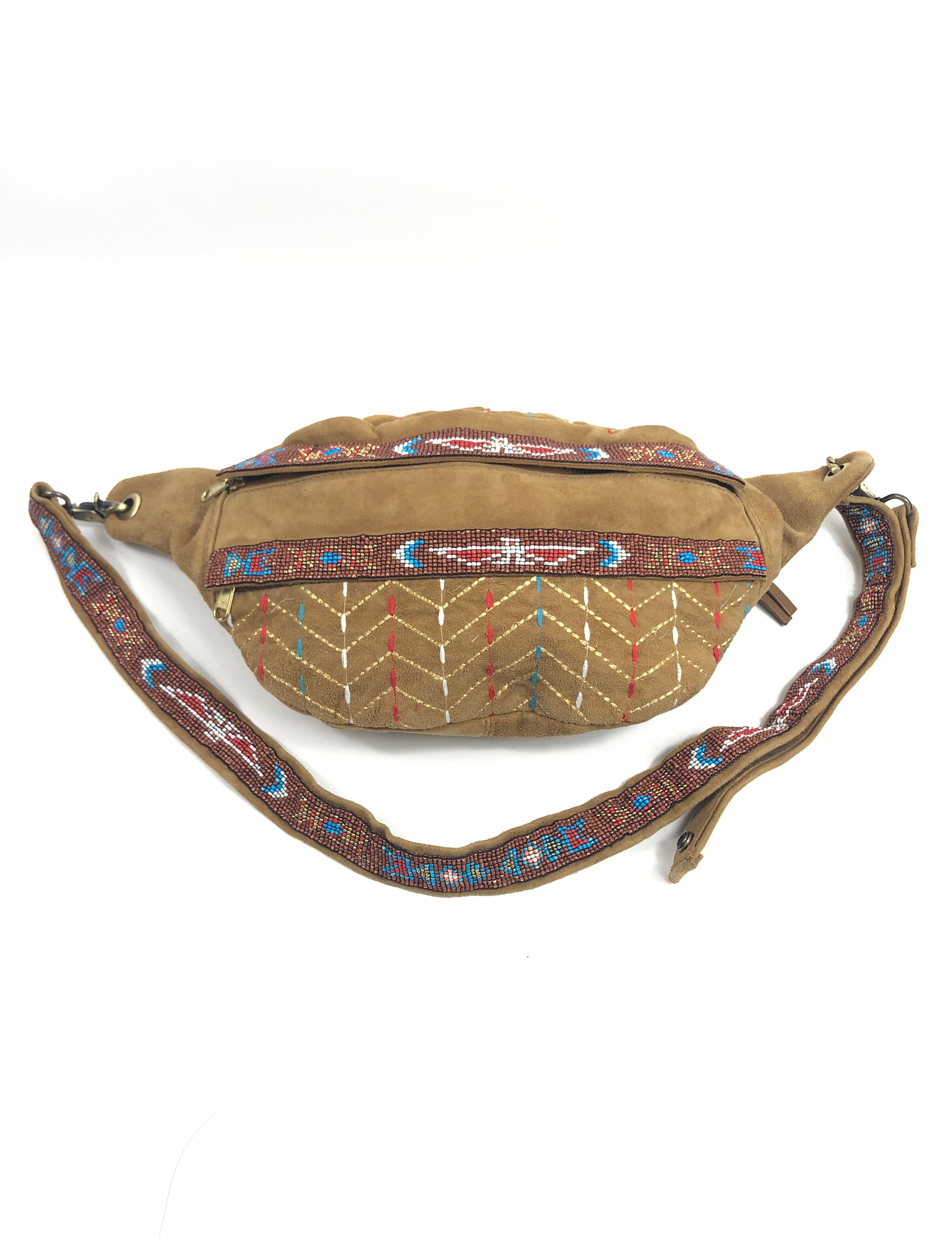 Beige bag with decorative strap on a white background