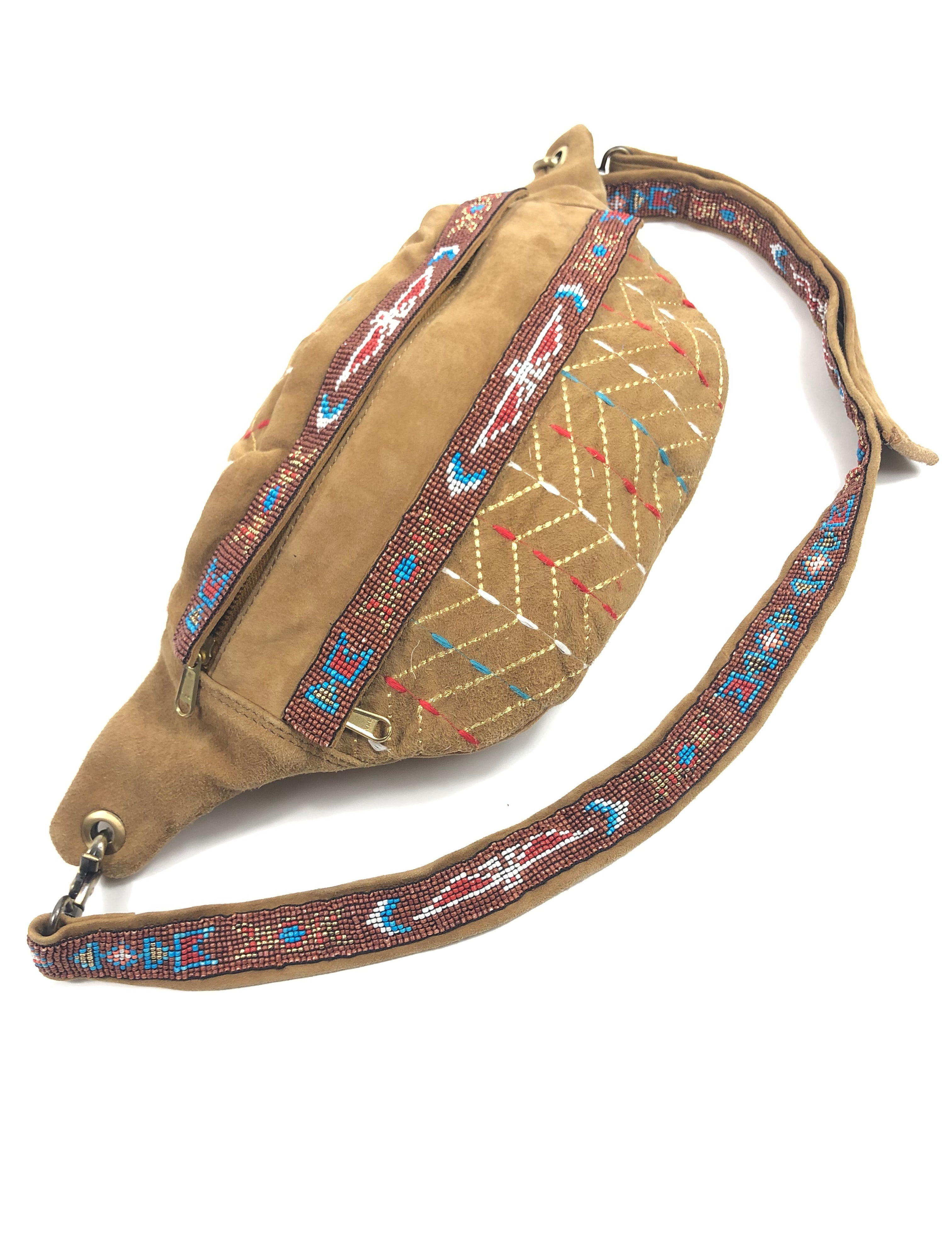 Beige waist bag with colorful patterned strap on a white background