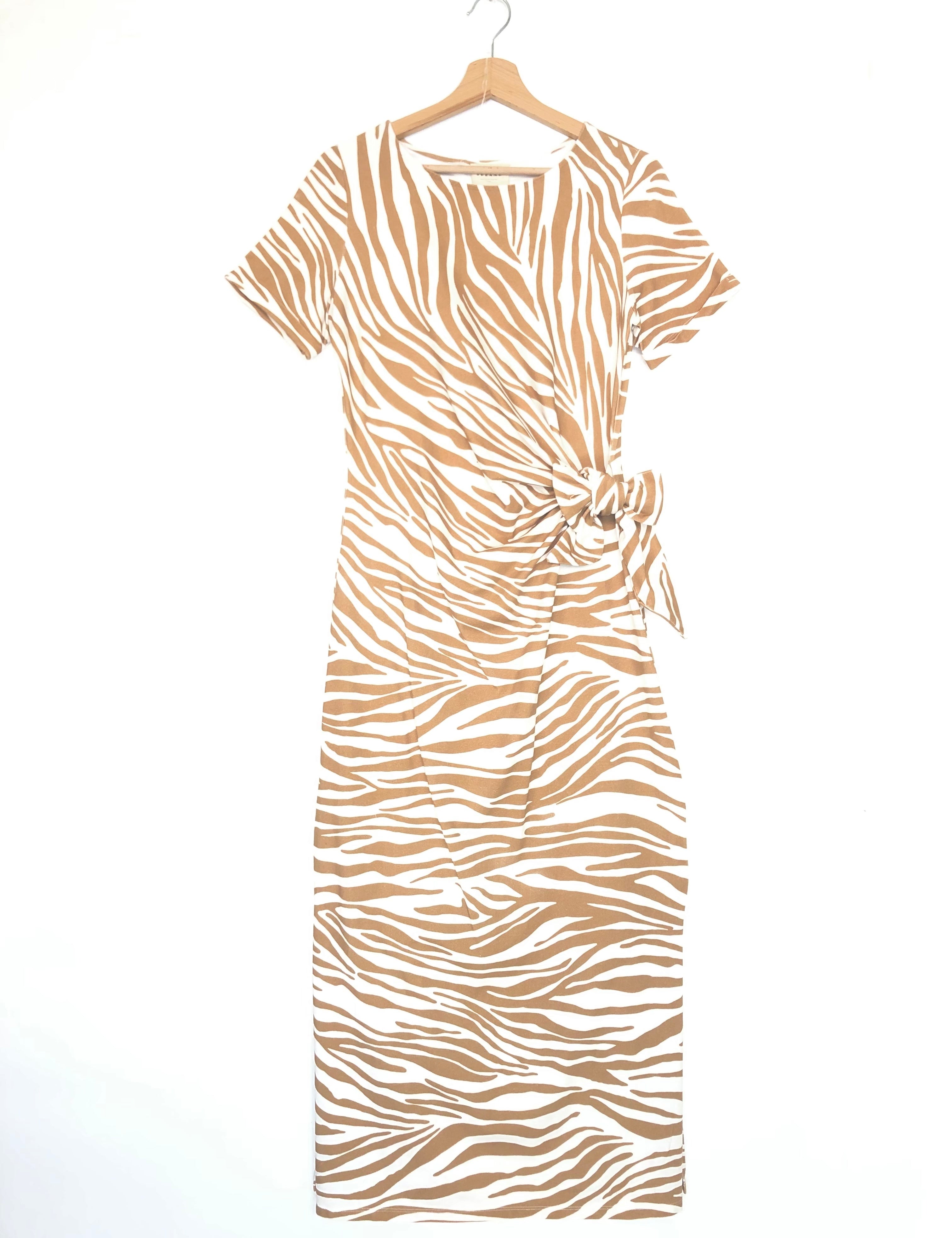 Beige and white zebra print dress on a hanger against a white background