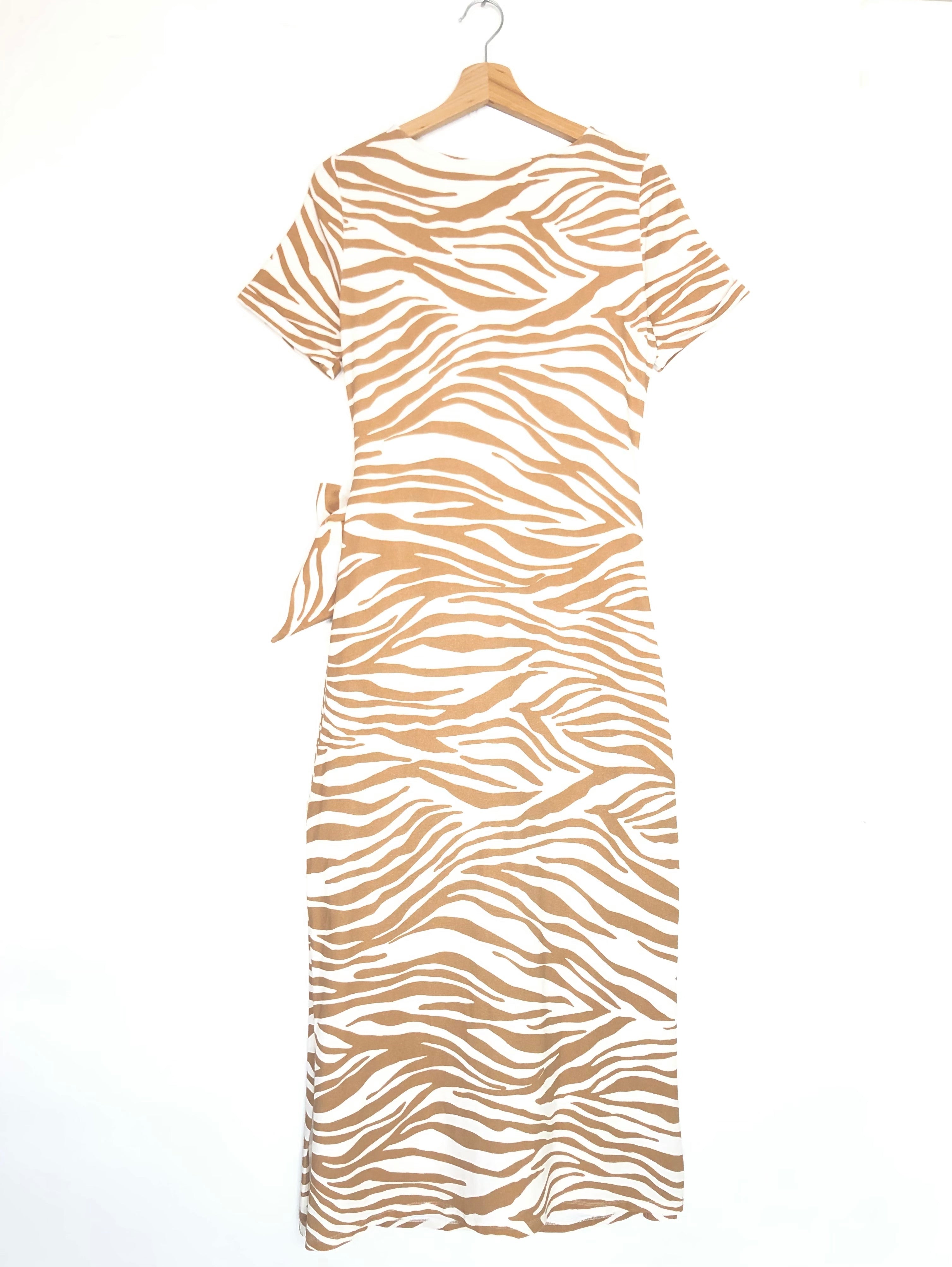 Beige and white zebra pattern dress on a hanger against a white background