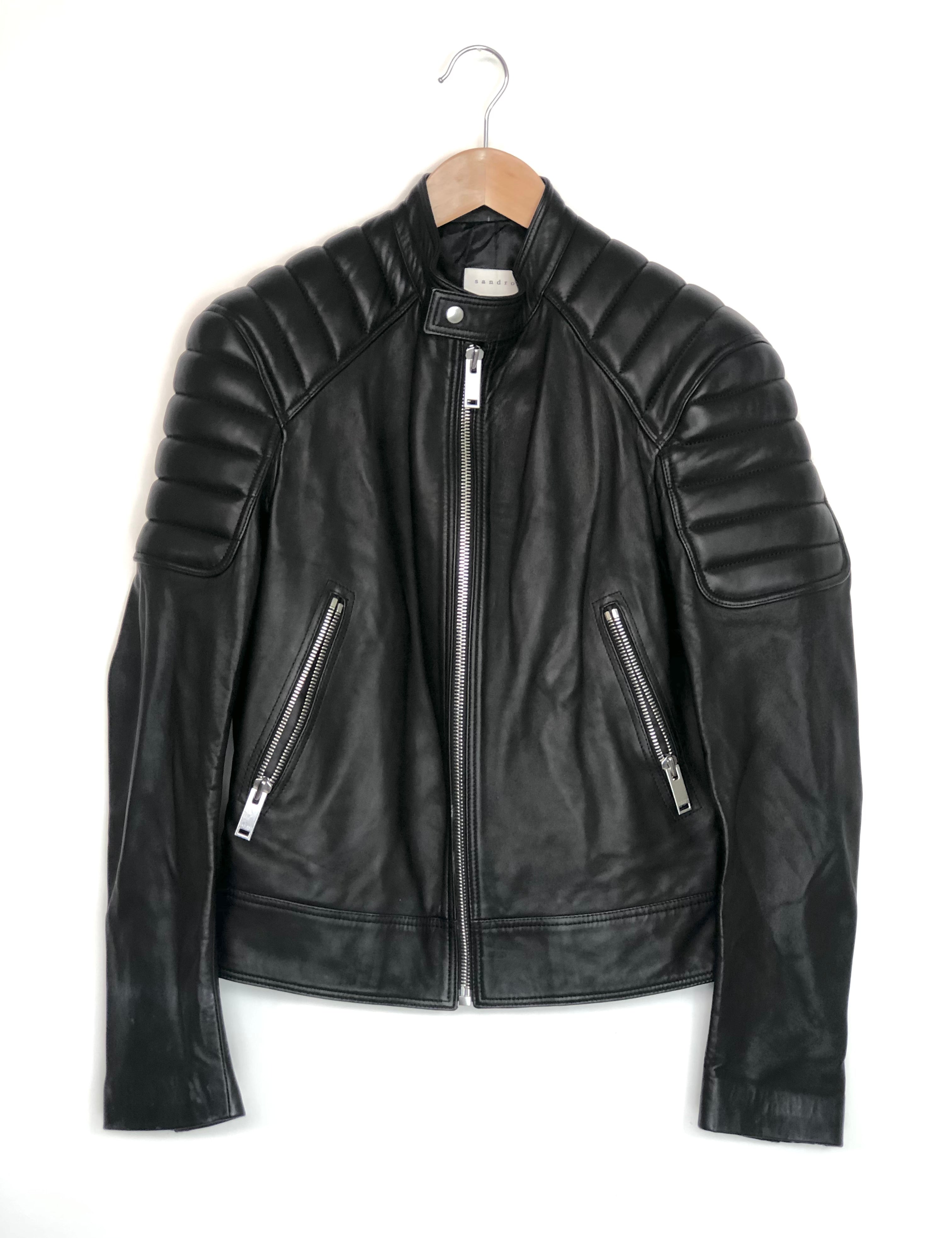 Black leather jacket on a hanger against a white background