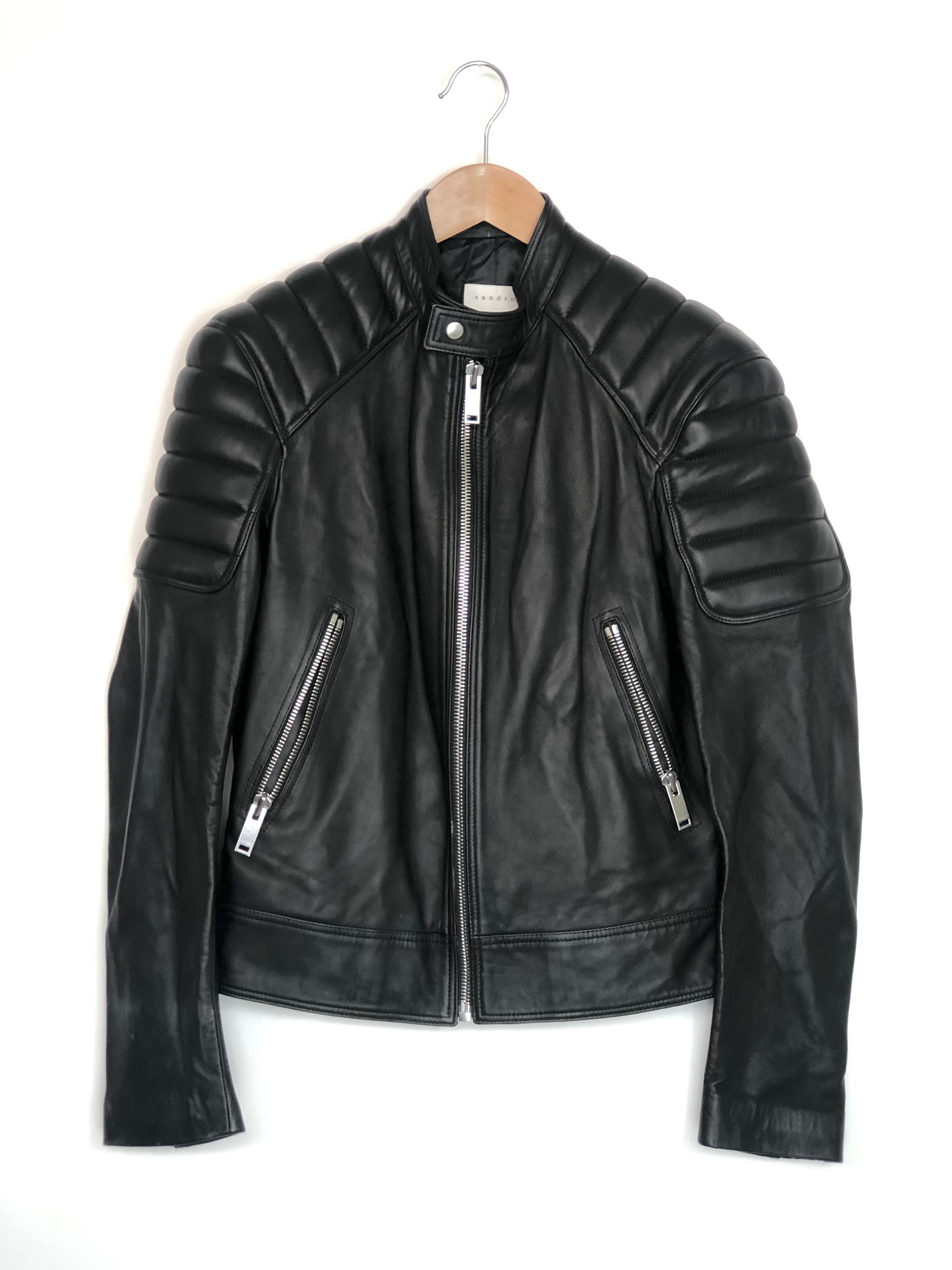 Black leather jacket on a hanger against a white background