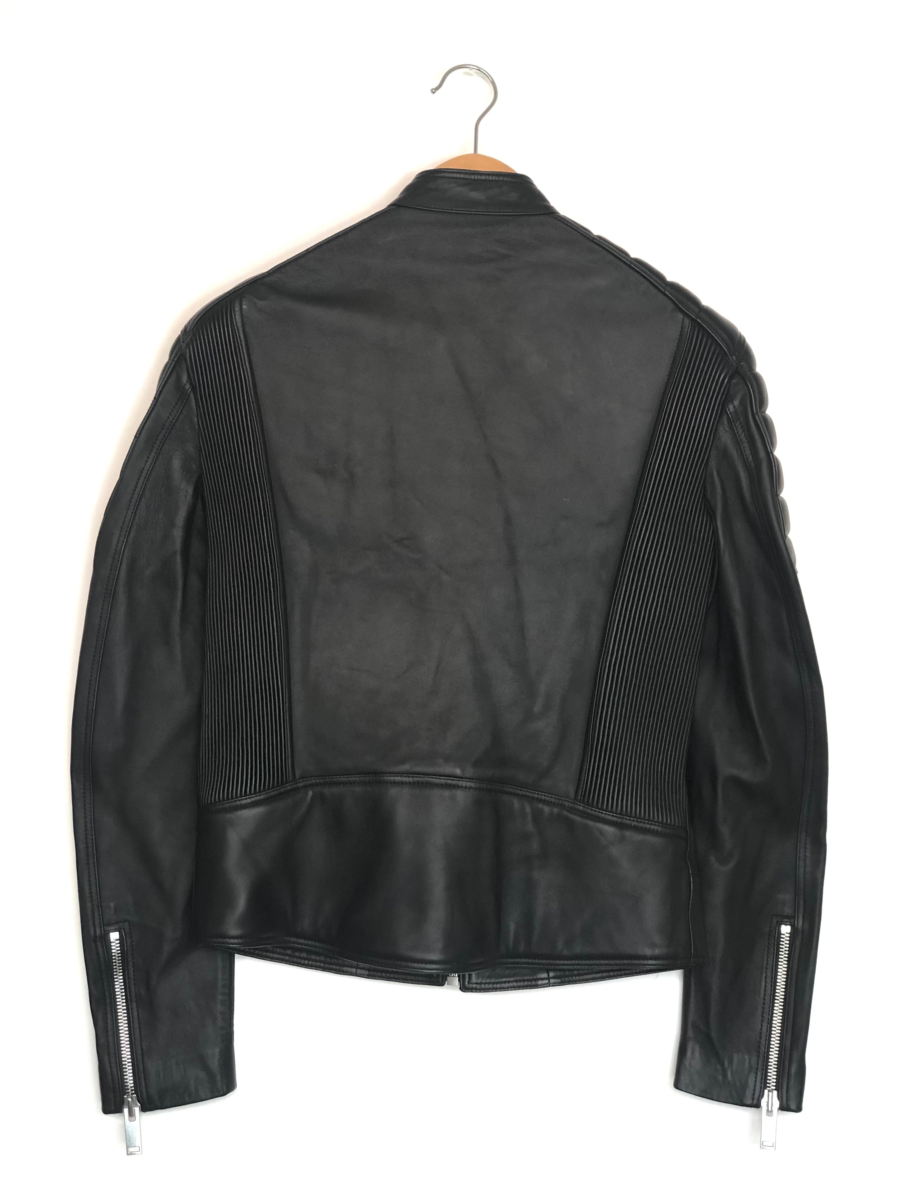 Black leather jacket on a hanger against a white background