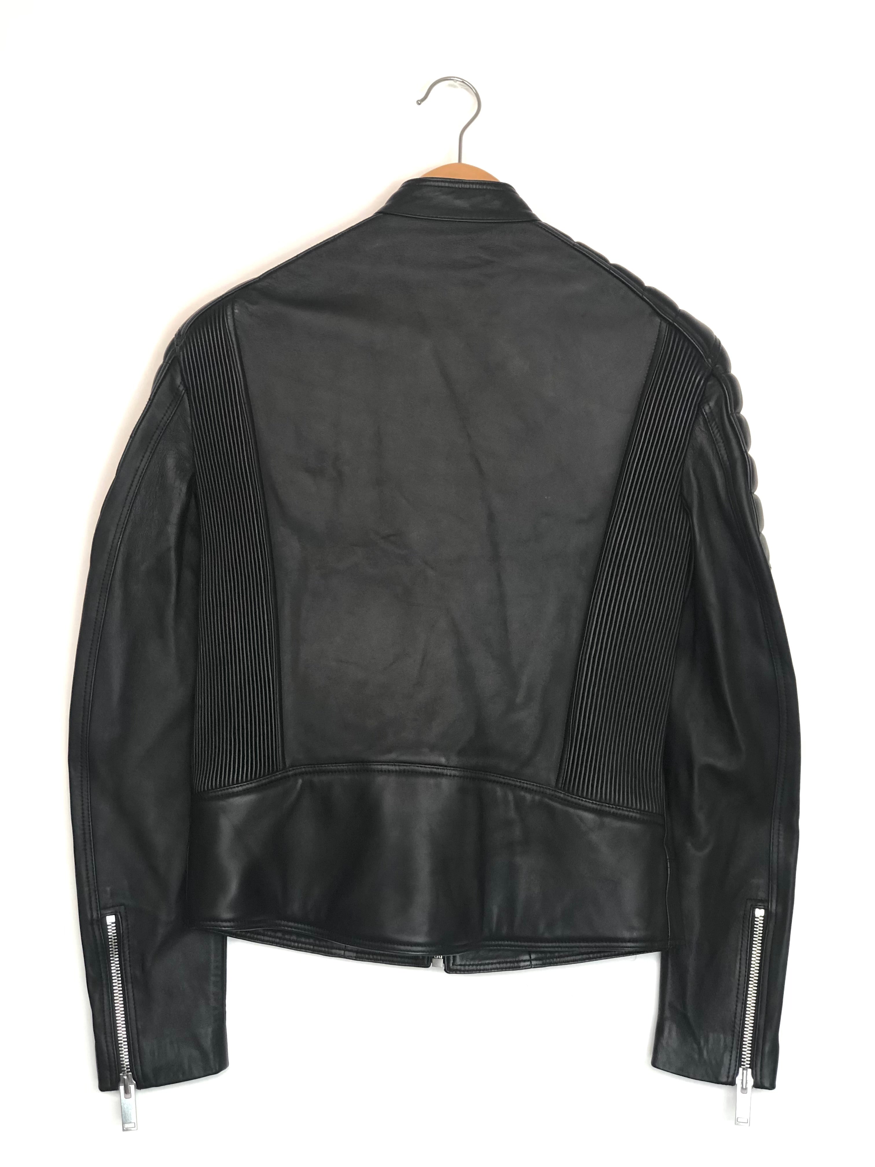 Black leather jacket on a hanger against a white background