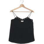 Black lace-trimmed top on a wooden hanger against a white background