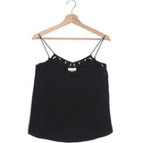 Black lace-trimmed top on a wooden hanger against a white background