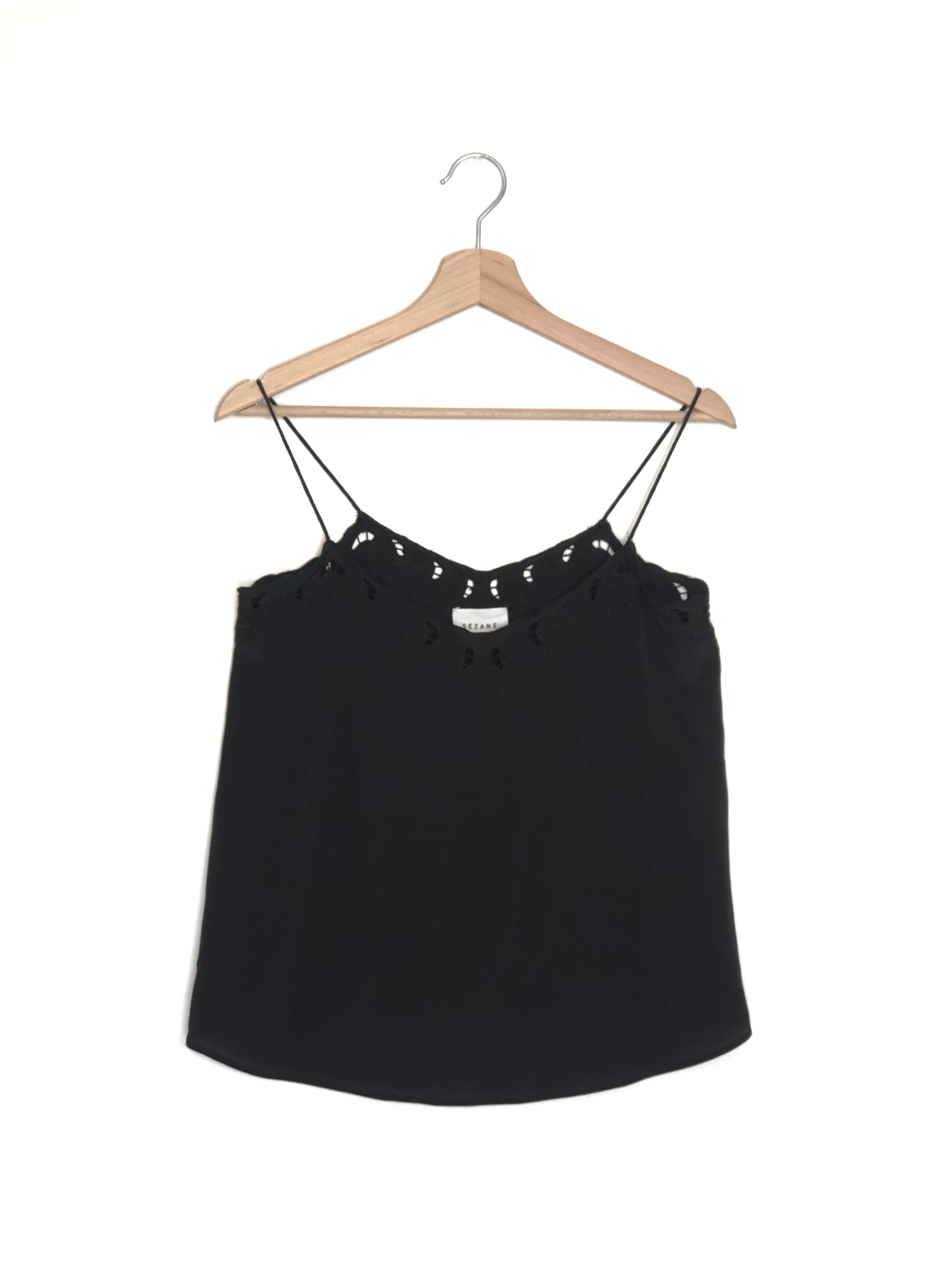Black lace-trimmed top on a wooden hanger against a white background