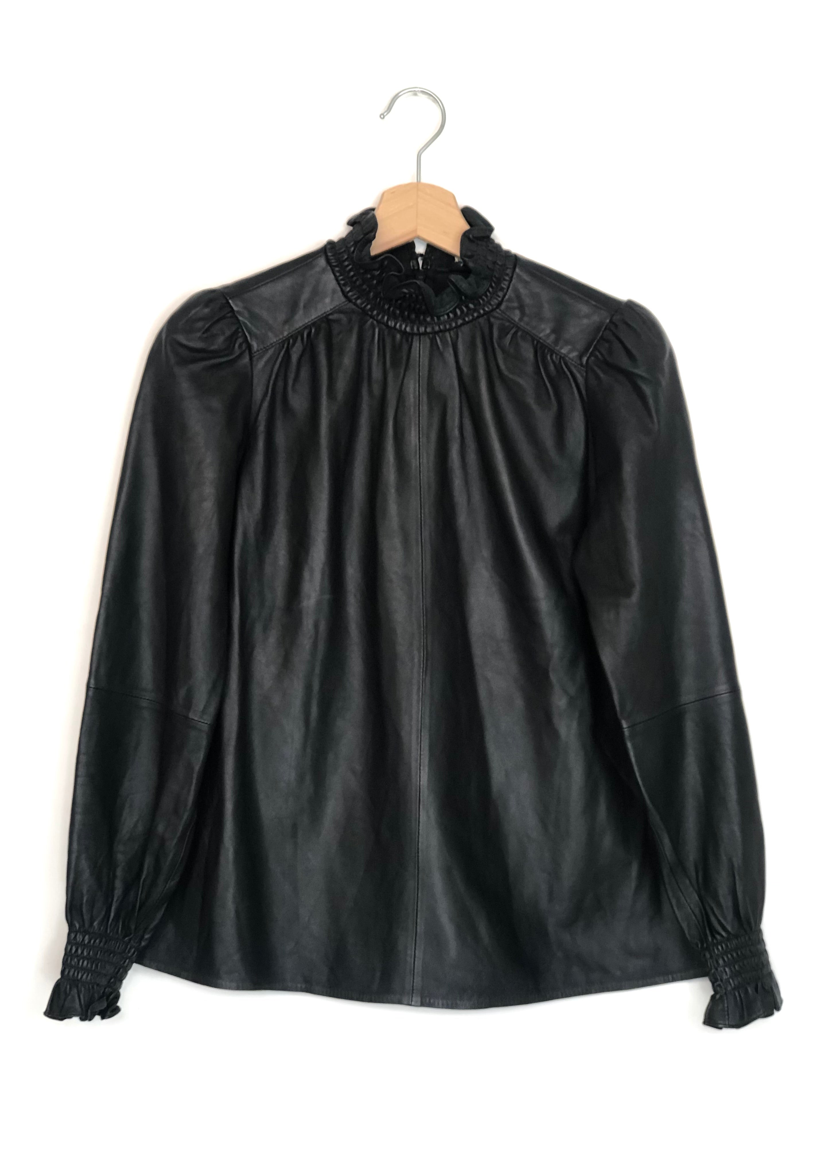 Black leather blouse with lace collar on a hanger against a white background