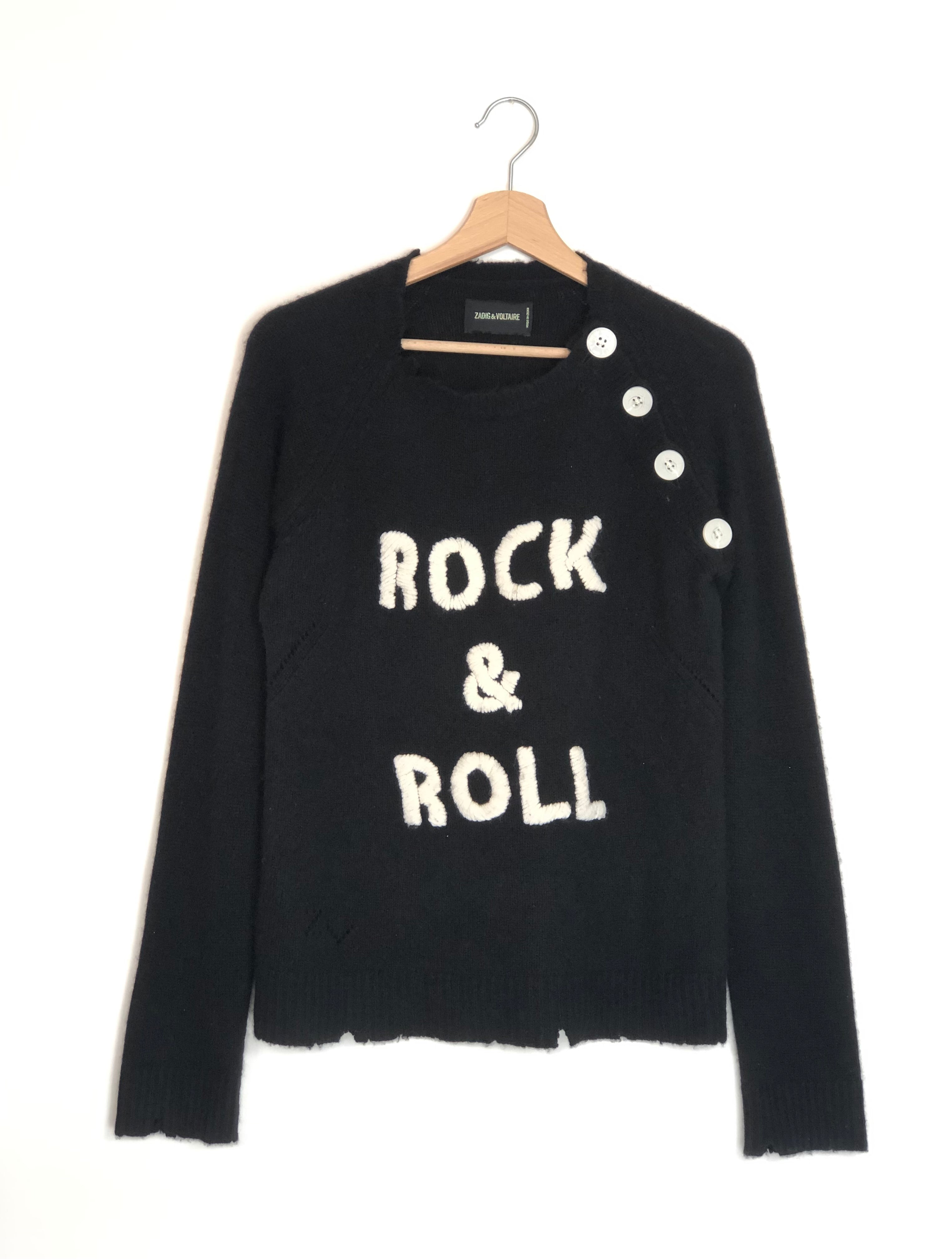 Black sweater with 'Rock & Roll' text on a hanger against a white background