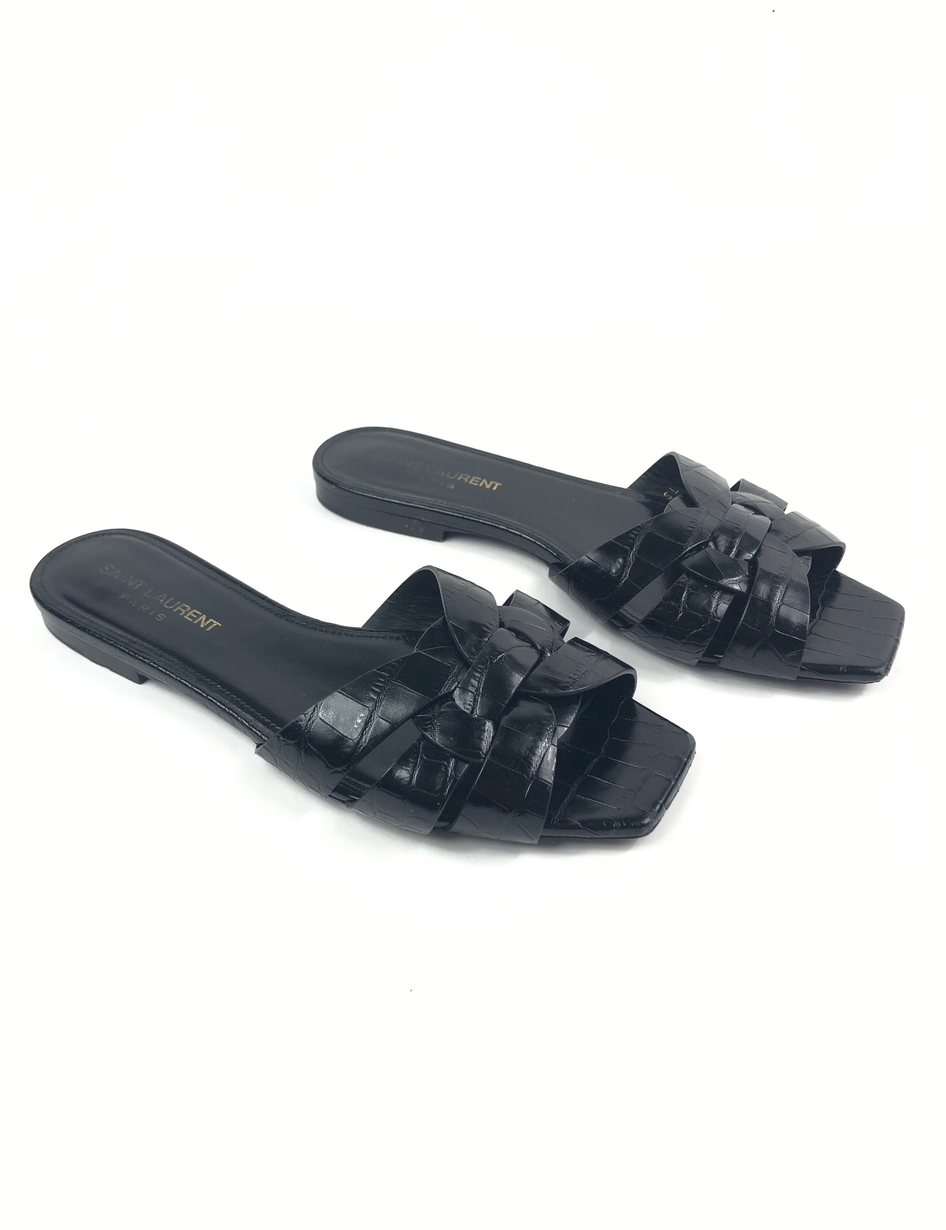 Pair of black sandals on a white background