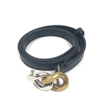 Black belt with metal clamps on a white background