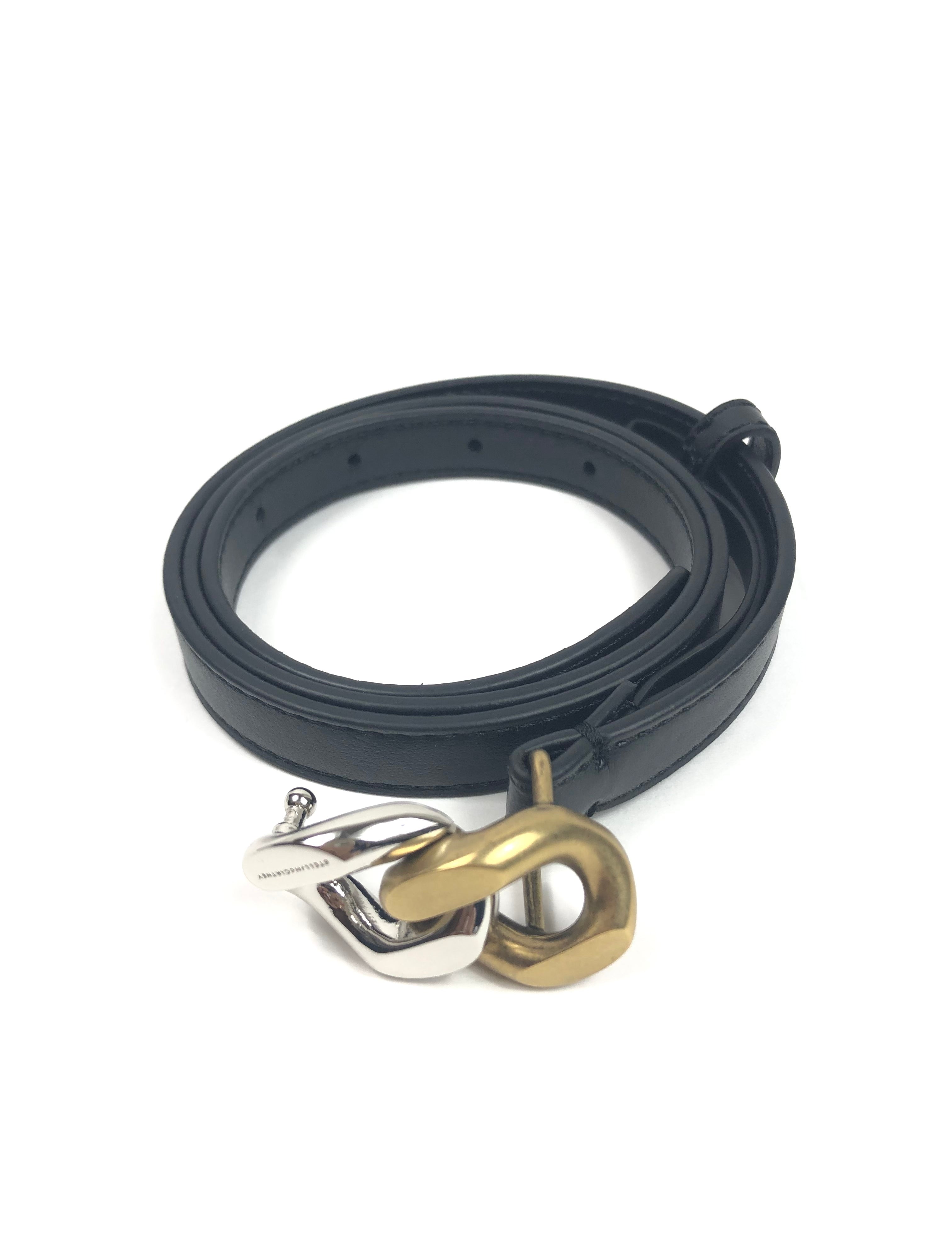 Black belt with metal clamps on a white background