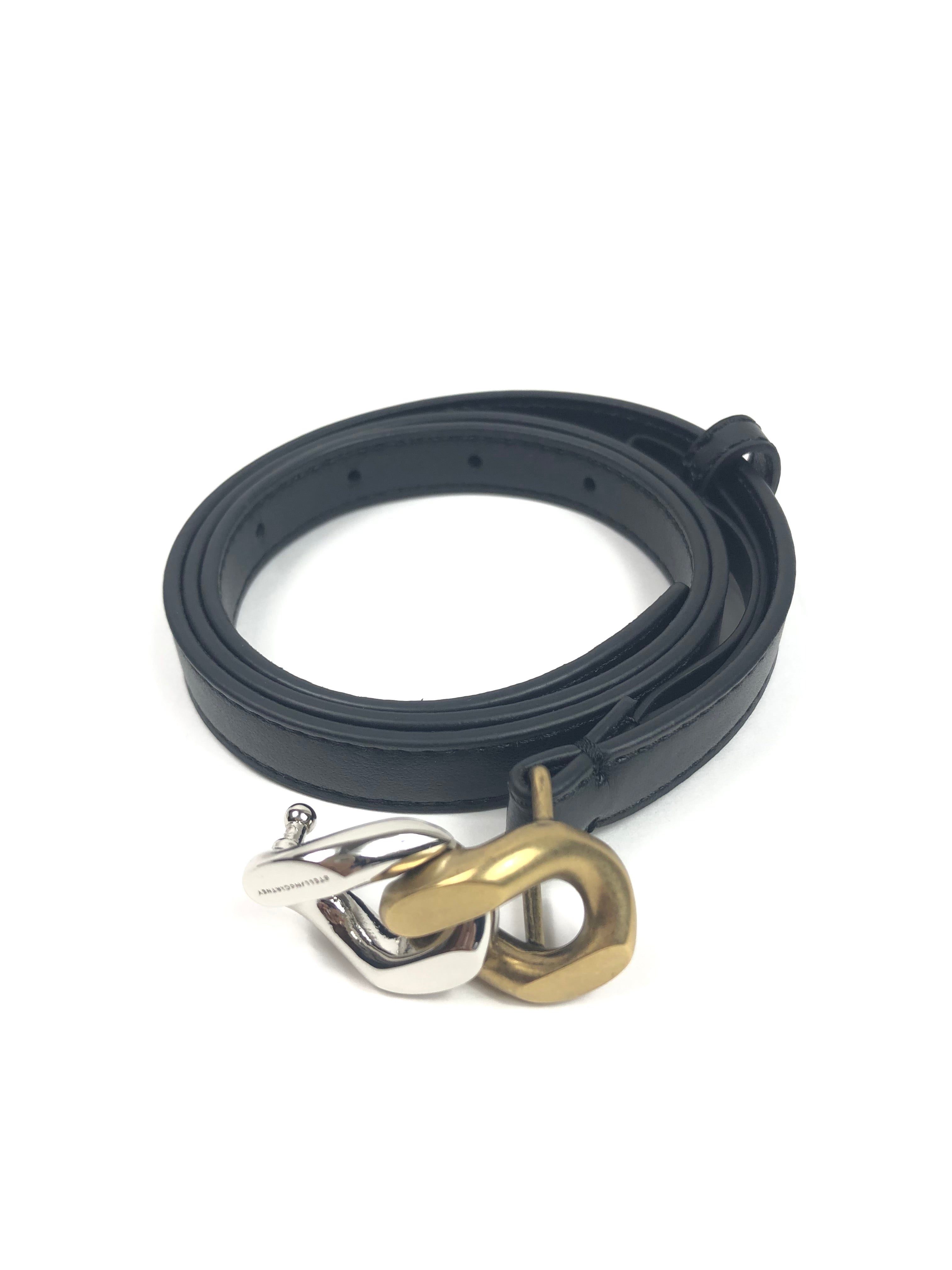 Black belt with metal clamps on a white background