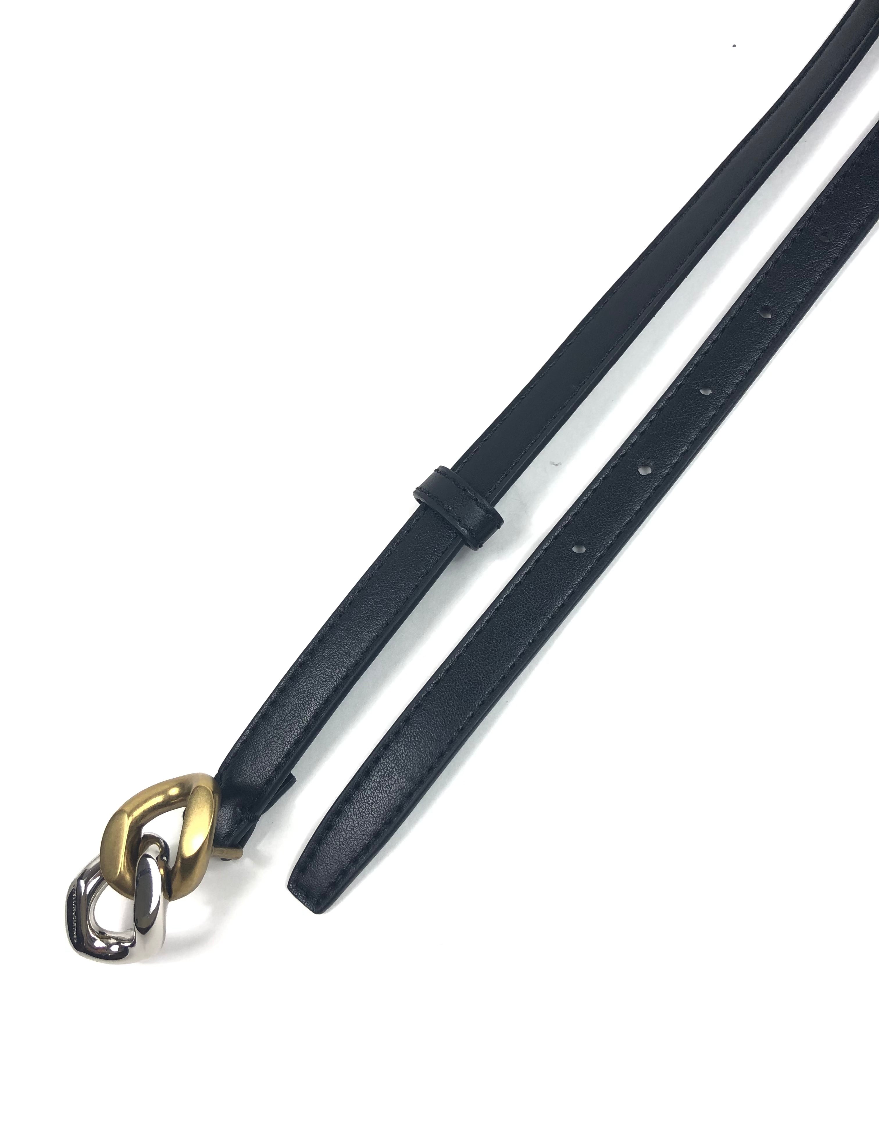 Black leather belt with a gold and silver clasp on a white background