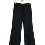 Black pants on a hanger against a white background