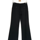 Black pants on a hanger against a white background