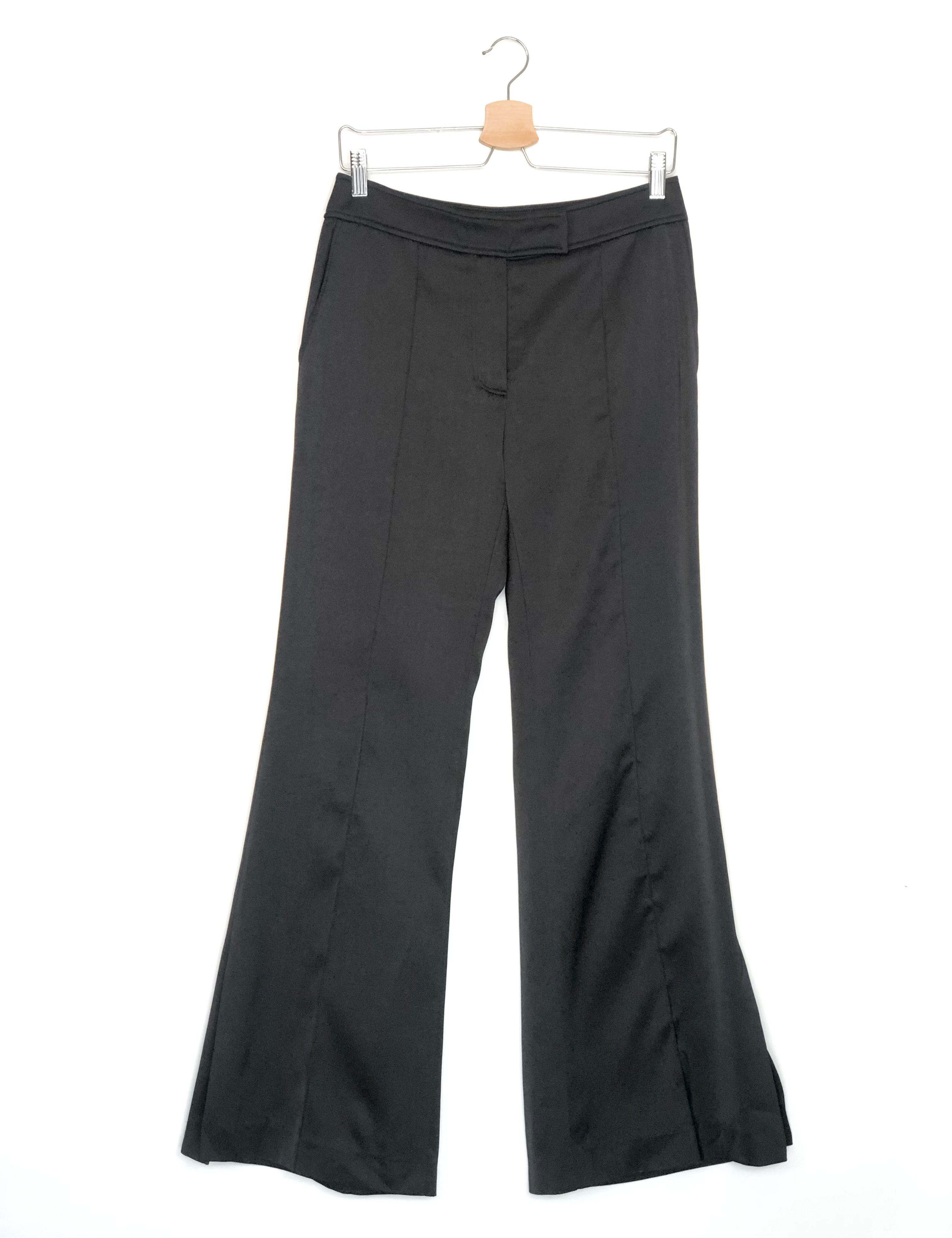 Black wide-leg pants on a hanger against a white background