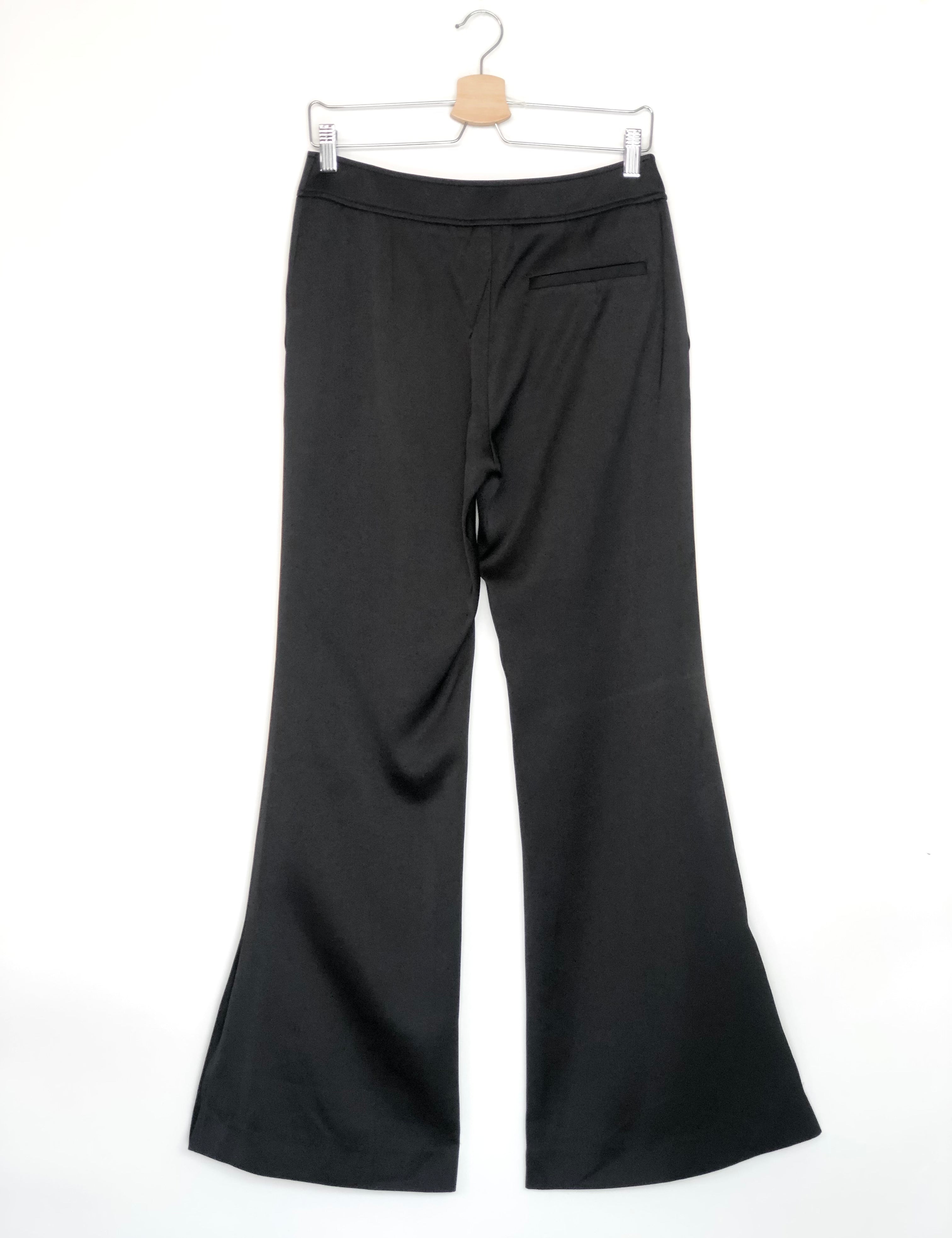 Black wide-leg pants on a hanger against a white background