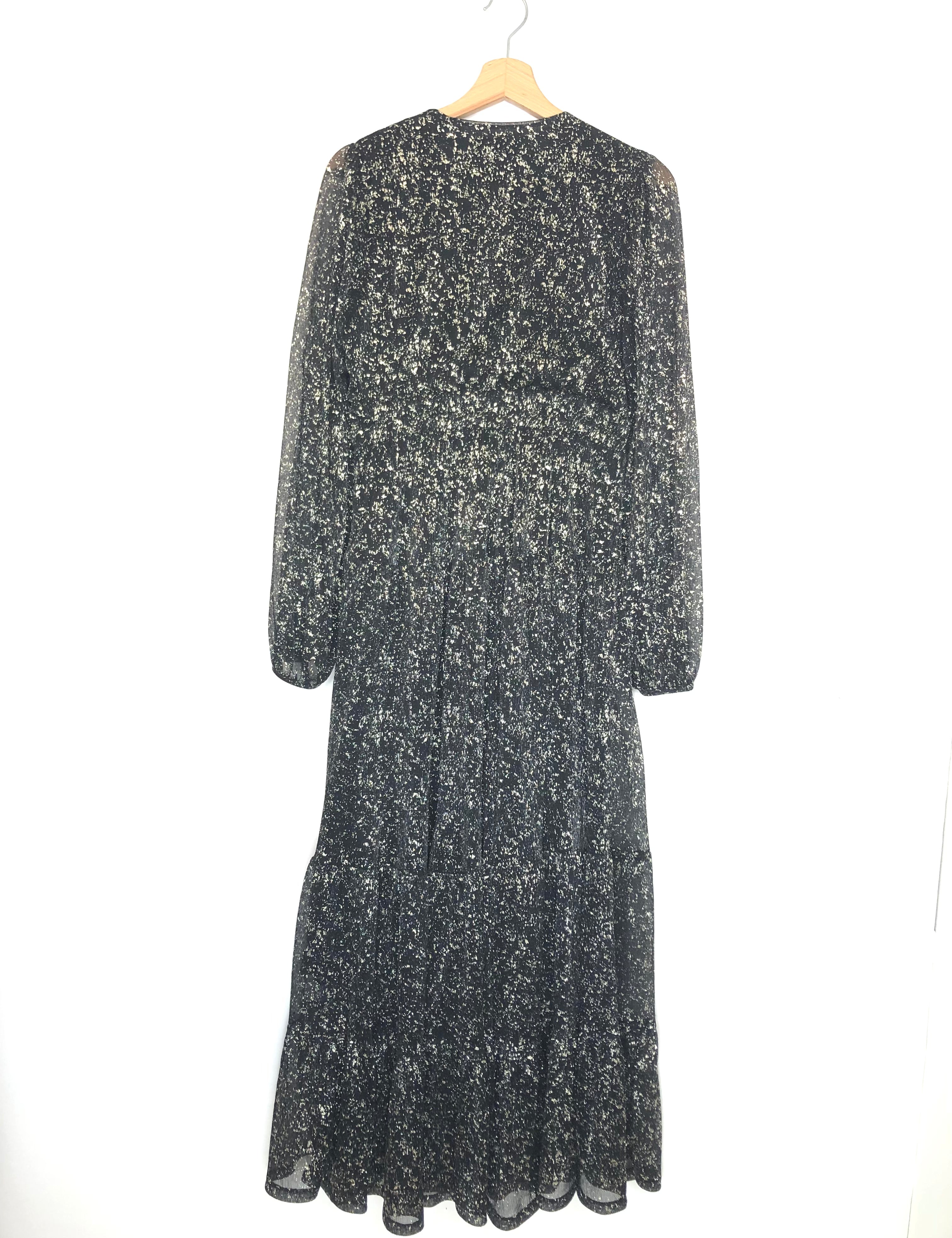 Long-sleeve dress with floral pattern on a hanger against a white background