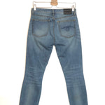 Blue jeans on a hanger against a white background