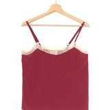 Maroon dress with lace trim on a wooden hanger against a white background