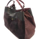 Brown and black handbag on a white background