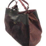 Brown and black handbag on a white background