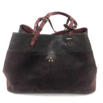 Brown leather handbag with gold accents on a white background