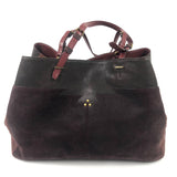 Brown leather handbag with gold accents on a white background