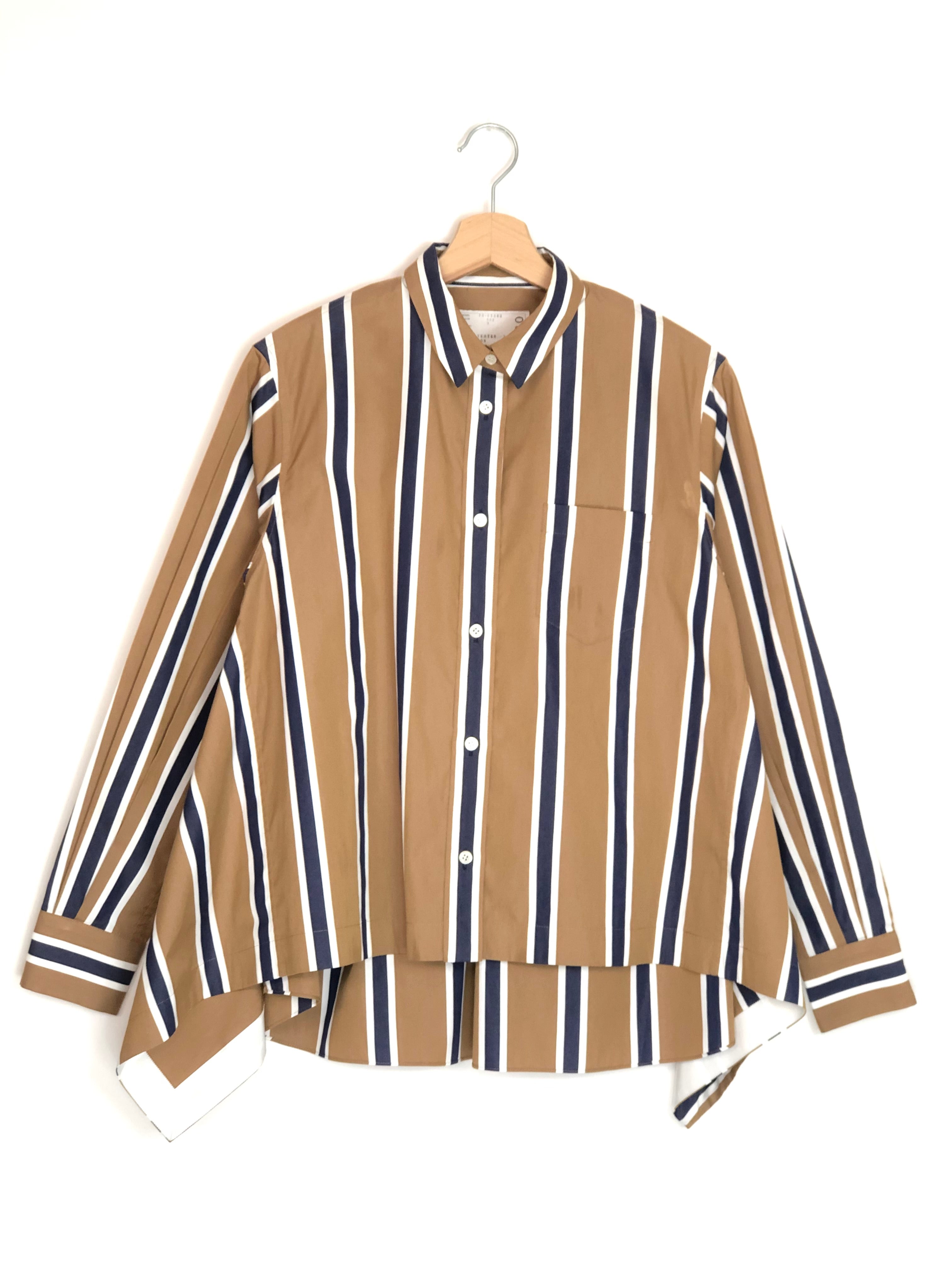 Striped shirt on a hanger against a white background