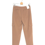 Beige pants hanging on a white background