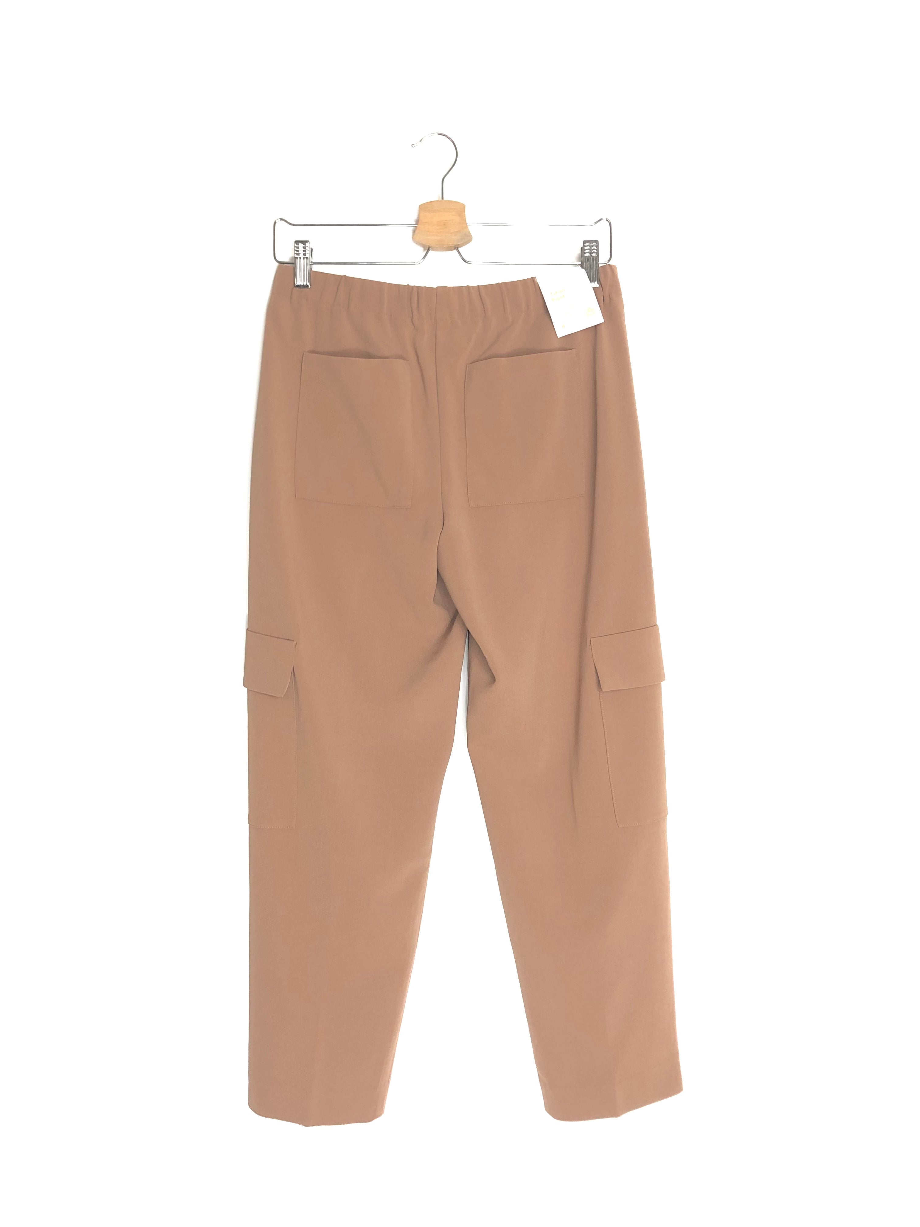 Beige pants hanging on a white background