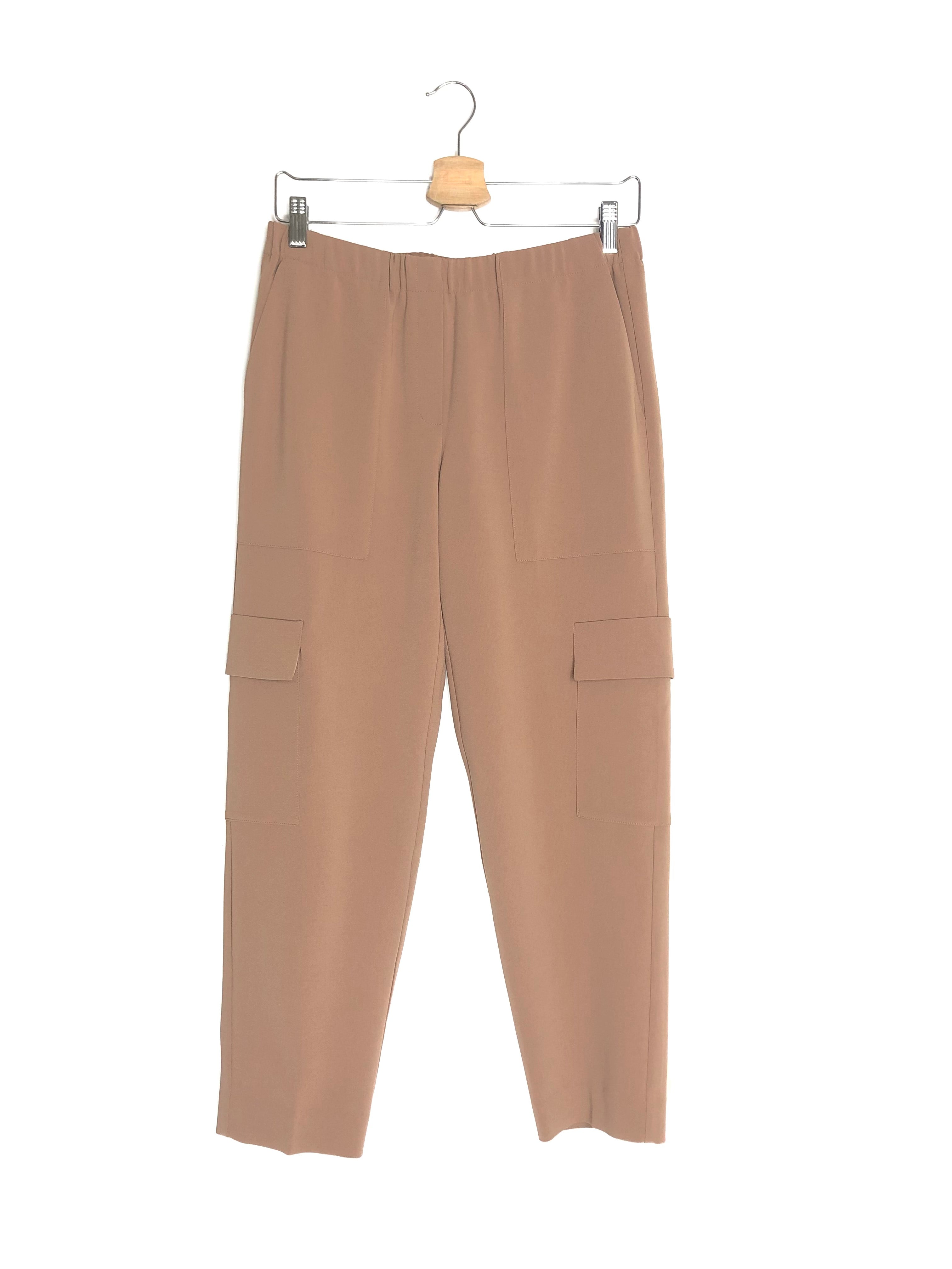 Beige pants on a hanger against a white background