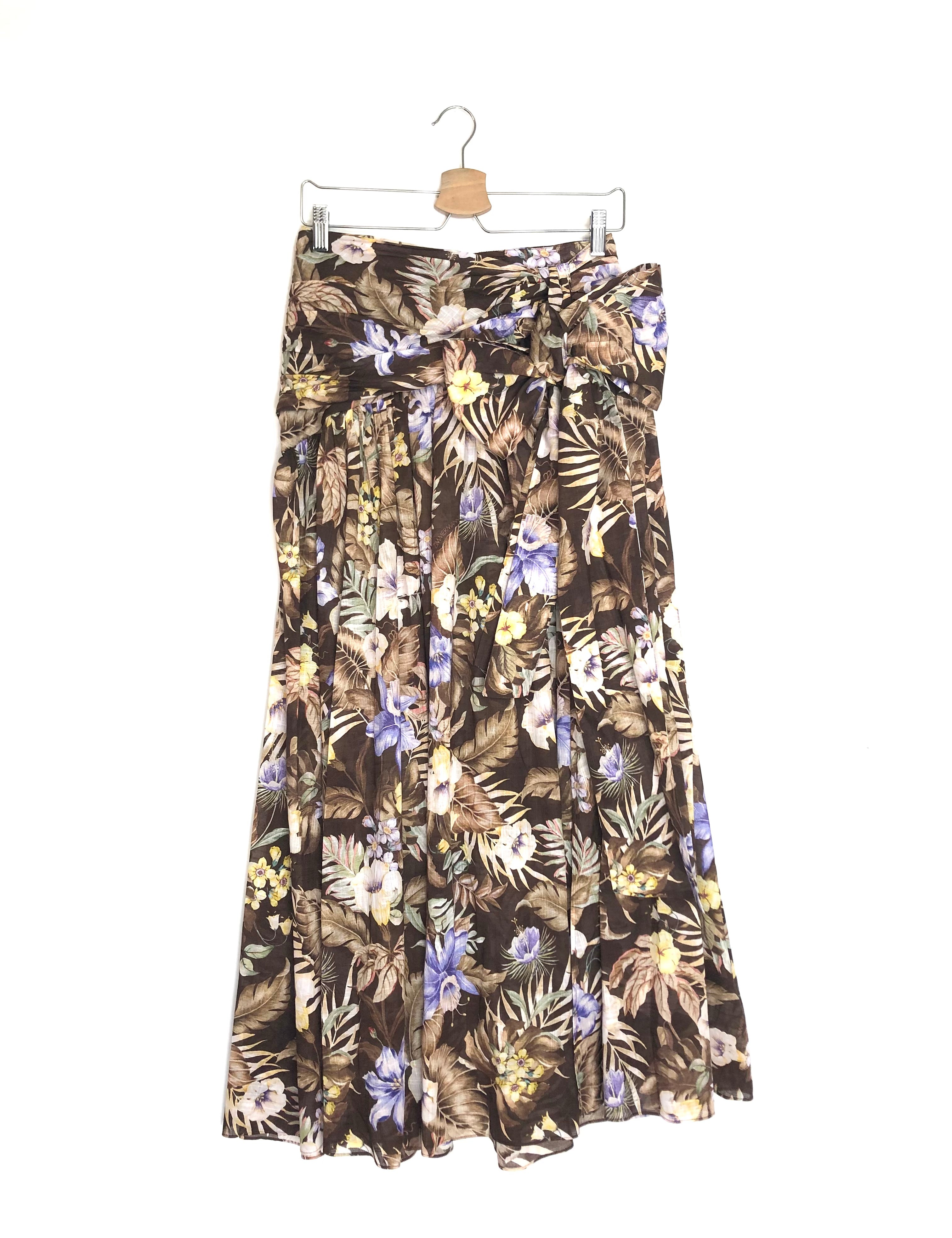 Floral patterned skirt on a hanger against a white background