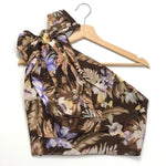 Floral-patterned top on a hanger against a white background