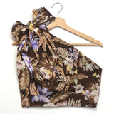 Floral-patterned top on a hanger against a white background