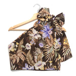 Floral halter top on a wooden hanger against a white background