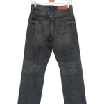 Black jeans on a hanger against a white background