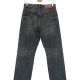 Black jeans on a hanger against a white background