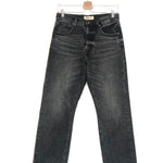 Black jeans on a hanger against a white background