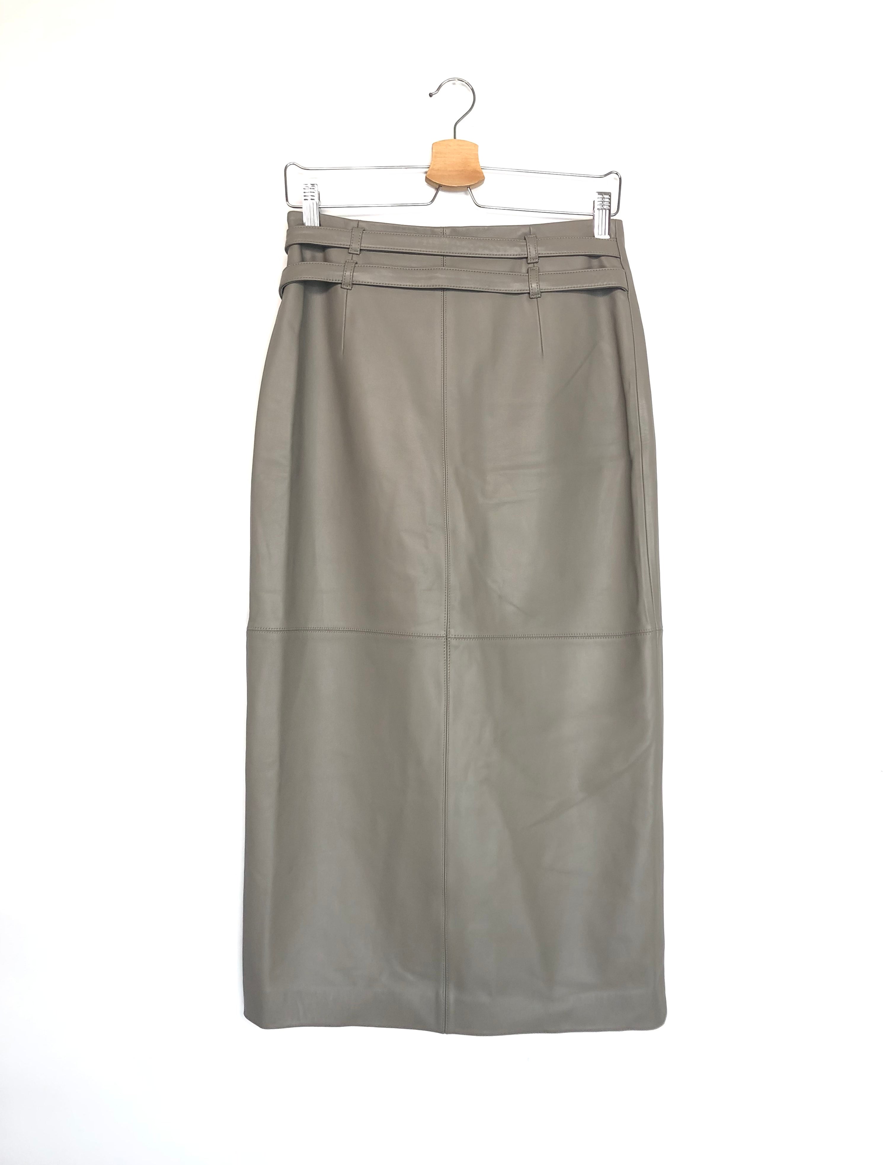 Gray leather skirt on a hanger against a white background