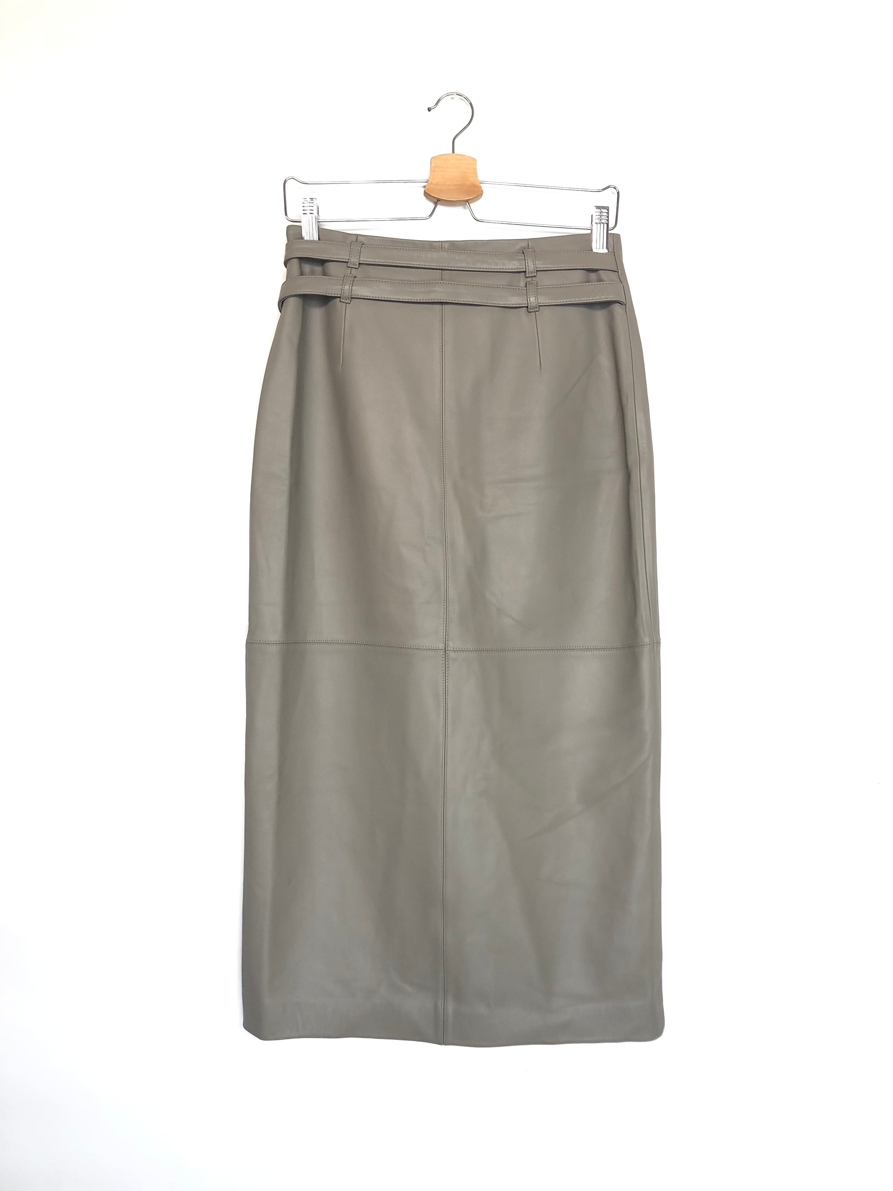 Gray leather skirt on a hanger against a white background