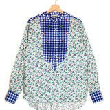 Floral and checkered blouse on a hanger against a white background