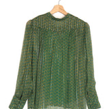 Green patterned blouse on a wooden hanger against a white background