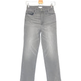 Gray jeans on a hanger against a white background